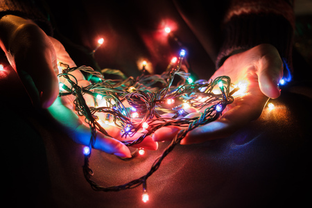 New Year eve photoset. New year garland in woman hands.の写真素材