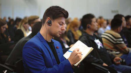 Crowd student study forum business man auditorium college. Education audience person write note....