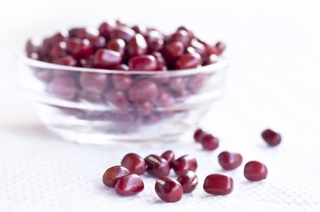 one glass cup more red beans in white paper