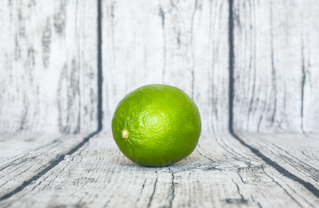 green lemon put on wooden tableの写真素材
