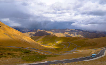 Autumn grassland under blue sky and white clouds in Tibetの写真素材