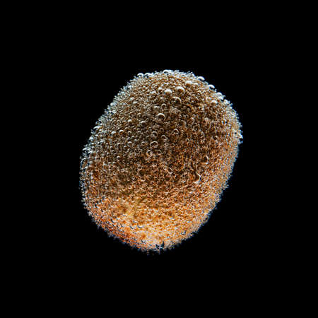 Kiwi under water, bubbls. isolated on black background