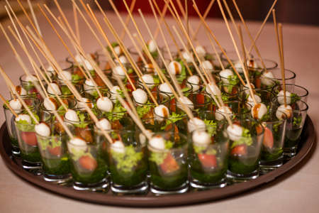 Canapes of quail egg, cheese, vegetables on the tray. Close-upの写真素材
