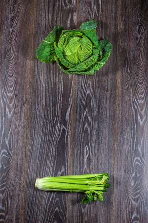 Savoy cabbage from organic grower farm, on black wooden background, top view.の写真素材