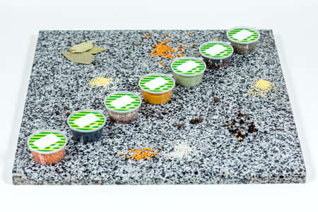 Dried spices in plastic containers on a marble background. Close-upの写真素材
