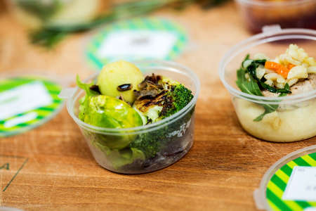 Various dishes in plastic container on wooden table. Close-upの写真素材