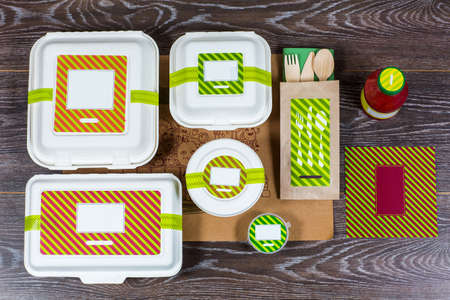 Food boxes and wooden cutlery on wooden table, top viewの写真素材