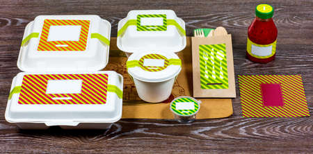 Food boxes and wooden cutlery on wooden table, top viewの写真素材