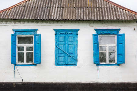 Old house wall with wooden windows