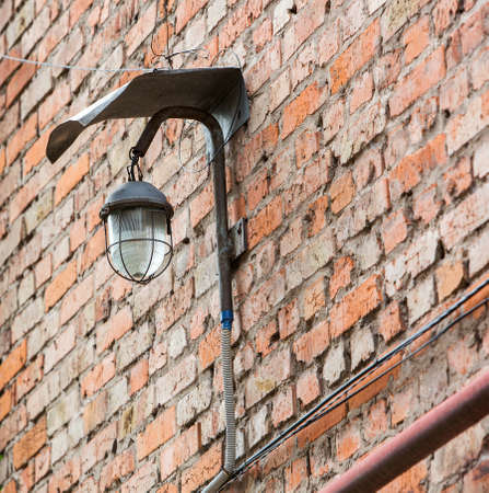 Lantern on brick wall of old city.の写真素材