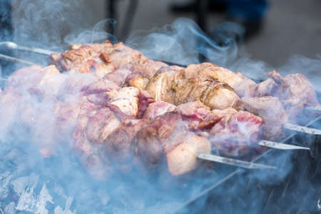 Smoky grilling the marinated pork meat delicious shashlik.の写真素材