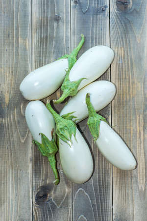 white eggplants on a wooden surfaceの写真素材