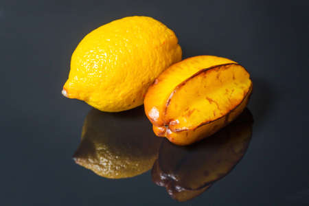 starfruit and lemon isolated on black