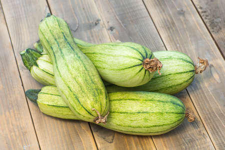 green zucchini on a old wooden boardの写真素材
