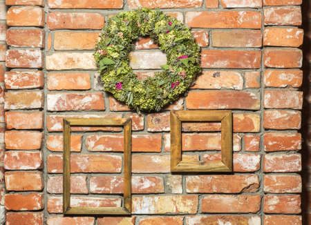flower wreath isolated on a Brick wall and framesの写真素材