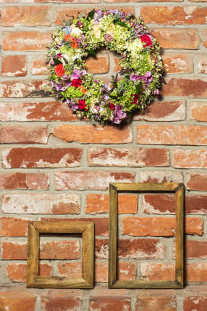 flower wreath isolated on a Brick wall and framesの写真素材
