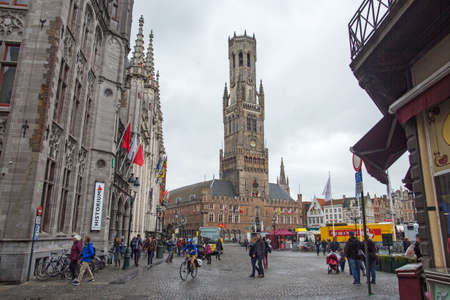BRUGGE, BELGIUM - JULY 4, 2017 : medieval Brugge streets with colorful buildings and people in squareのeditorial素材