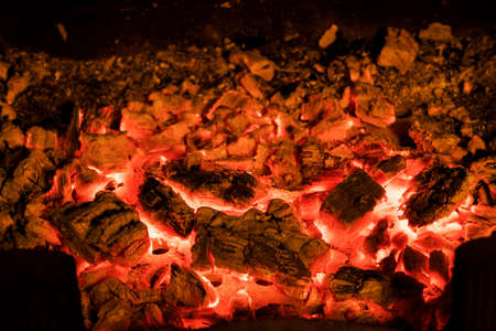 Photo of hot sparking live-coals burning in a barbecue.