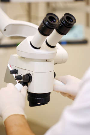 Scientist hands with microscope, examining samples and liquid. Medical research with technical...