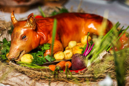 Baked small pig with vegetables. The concept of food and Ukrainian cuisineの写真素材
