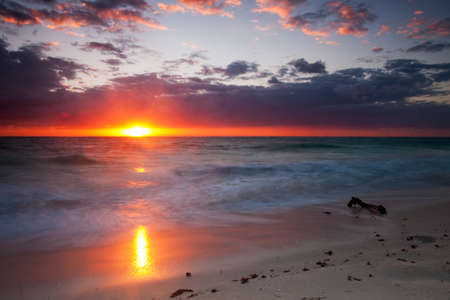 Sunrise in Cancun Mexico with sun rays coming through the clouds