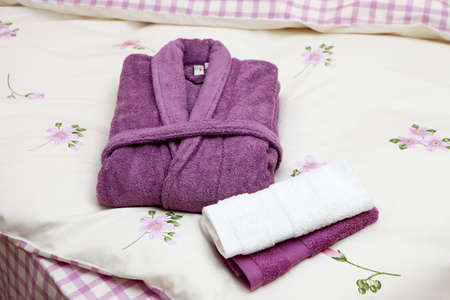 Stack of clean towels on bed