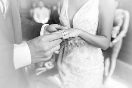 The wedding rings. Hands of the bride and groom with wedding rings.の写真素材