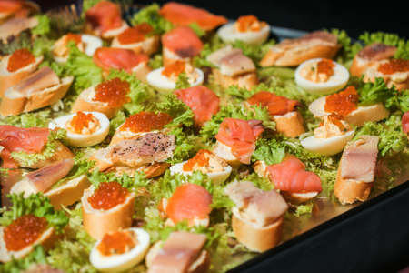 Sandwiches with caviar. Red caviar. Food on the holiday table. Snacks on a plate.の写真素材