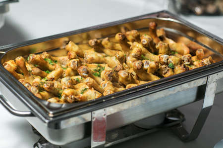 Baked chicken drumsticks on a baking tray