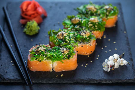 Sushi rolls with seafood and Chuka salad. Green sushi. Top view. Free space for your text..の写真素材