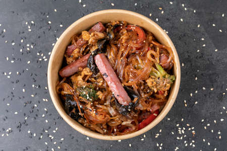 Stir fry noodle with chicken in a wok pan.の写真素材
