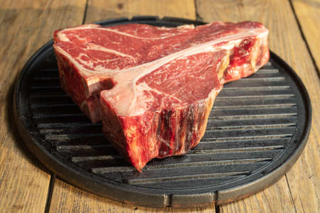 Thick Raw T-Bone Steak with Seasoning and Rosemaryの写真素材