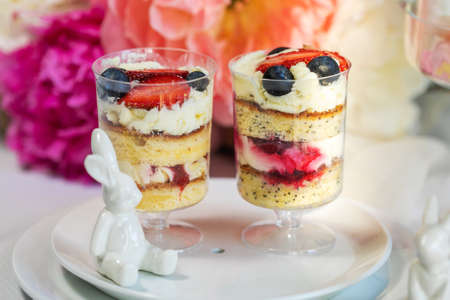 Strawberry cheesecake in glasses with fresh strawberries and cream cheese on wooden background. Healthy homemade dessert.の写真素材