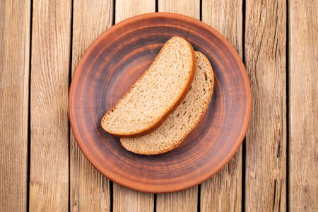 Plate with slices black bread on vintage wooden tableの写真素材