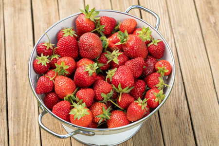 Strawberry in a Bowl on wooden backgroundの写真素材