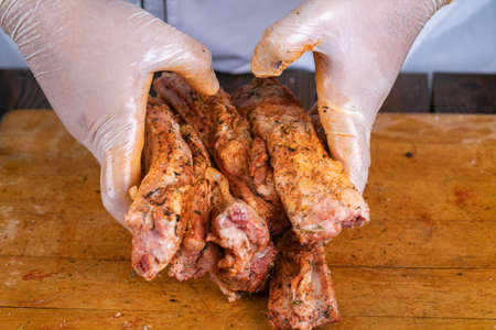 Preparation and cooking of pork ribs by a chef for a grill.の写真素材