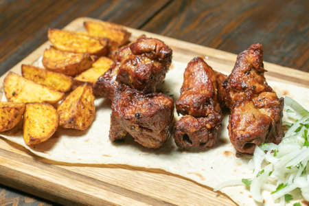 Grilled meat with potatoes and onionの写真素材