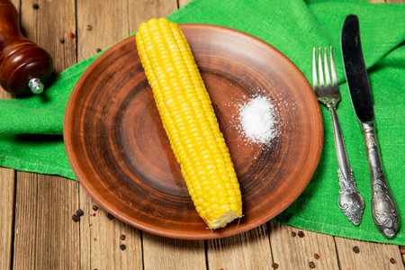 Four corn cobs on the dishの写真素材