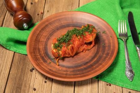 Roasted meatballs under meat sauce on plateの写真素材