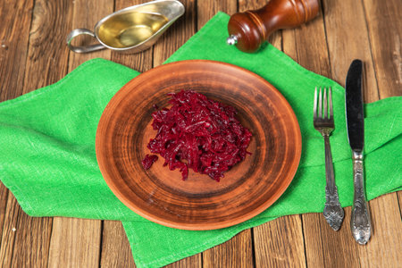 Raw grated beet in plate on wooden background.の写真素材