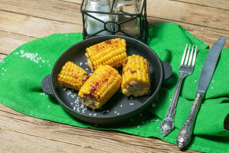 Grilled corn cobs on wooden background, top viewの写真素材