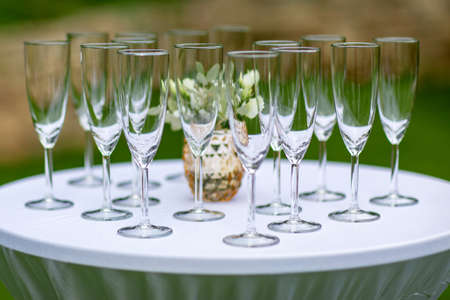 Waiter holding a lot champagne glassesの写真素材