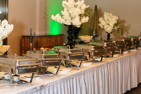 Buffet style food in trays on the tableの写真素材