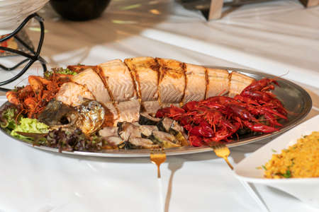 Baked salmon with mackerel and crayfishの写真素材