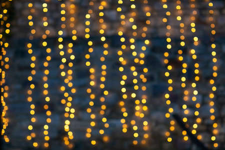 Yellow abstract bokeh made from Christmas lights on black isolated background. Holiday concept, blur bokeh, overlay for your images.の写真素材