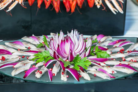 herring slice pieces of fish with onion seafood healthy meal food snack on the tableの写真素材