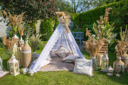 Street decorations prepared for a birthday, wigwam in summer green gardenの写真素材