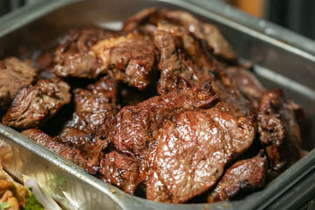 Grilled beef steak in sauce on a trayの写真素材
