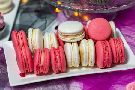 Macaroons. Delicious french desserts. Macaroons with raspberries and cream cheese. Macaroons on the tableの写真素材