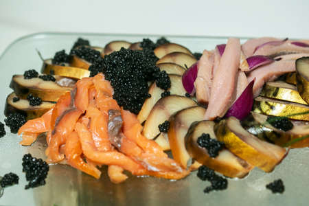 Fish plate with different types of smoked and salted fishの写真素材